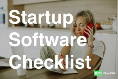 Women on phone at kitchen table - software startup checklist