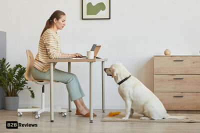 woman working remote with doggy - b2b reviews logo