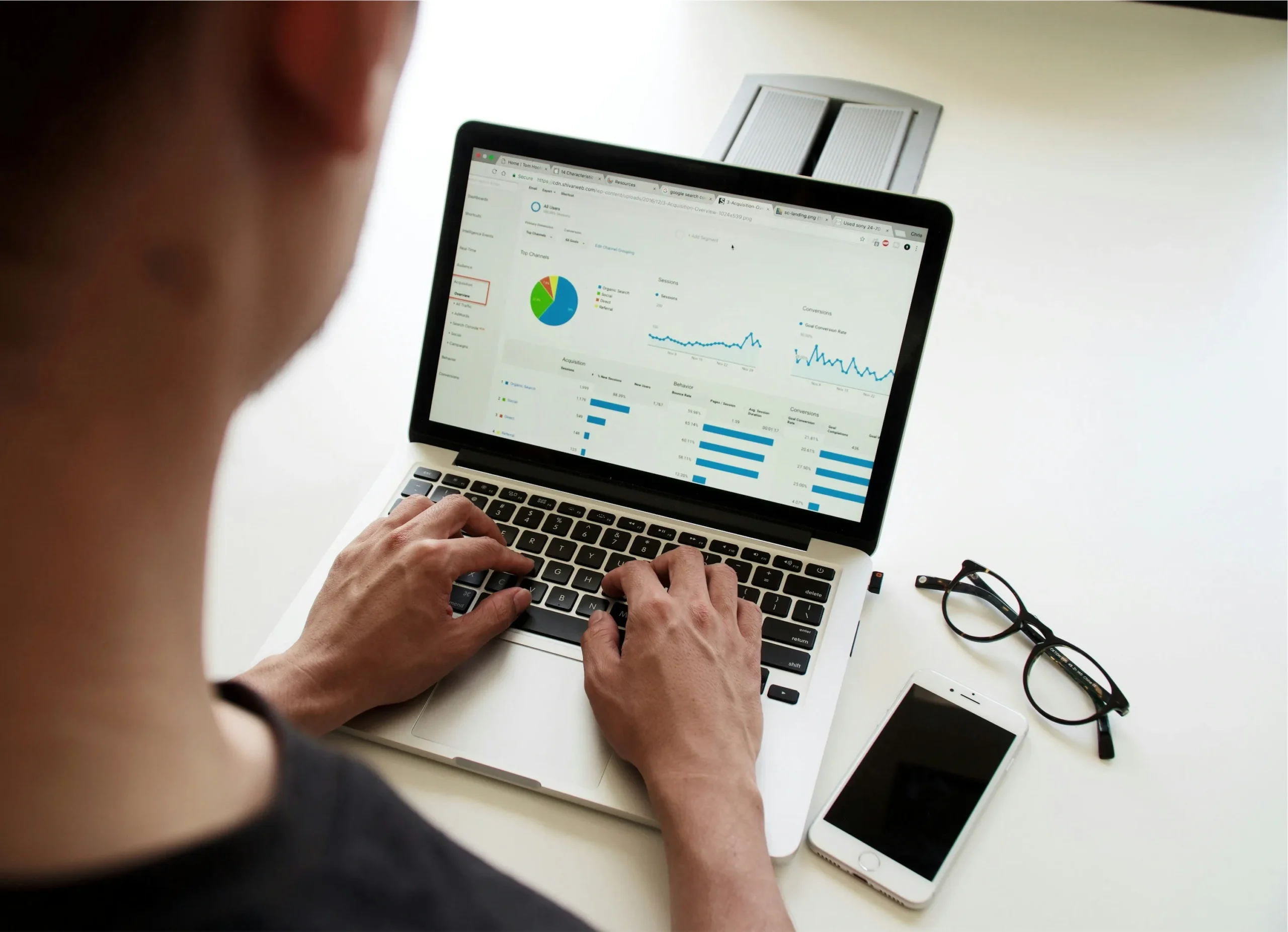 person looking at graphs on laptop