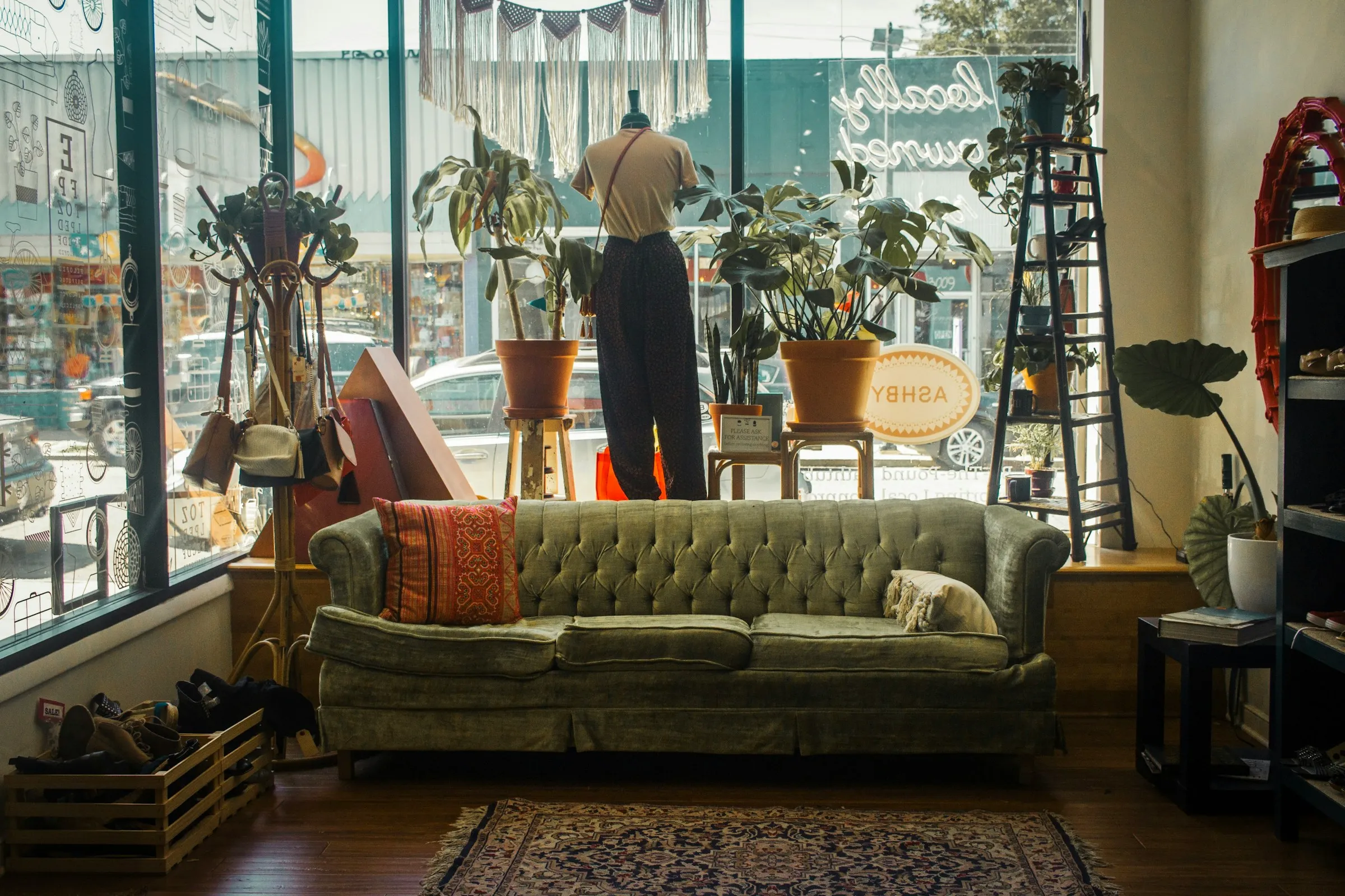 Green couch in front of a window in a thrift store: Photo by Darrien Staton on Unsplash